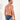 Man wearing blue tanga briefs with yellow abstract pattern on a white background