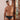 Man wearing a patterned underwear standing in a room with wooden doors.