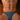 Person wearing blue micro briefs with a pattern on a wooden floor.