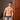 Man wearing blue underwear standing in a room with wooden door and neutral walls.