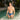 Man in blue swim trunks standing in a pool with palm trees and a building in the background