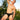 Man in black underwear standing outdoors with trees and a building in the background