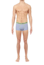 Man wearing grey boxer briefs with a green waistband on a white background