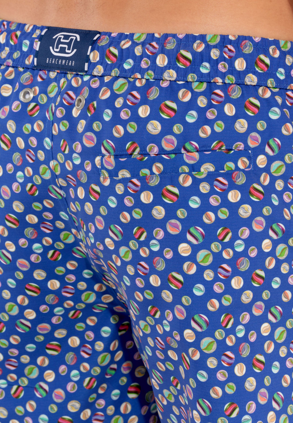 A pair of navy blue beach boxer shorts with a colorful marble print and a drawstring waist.