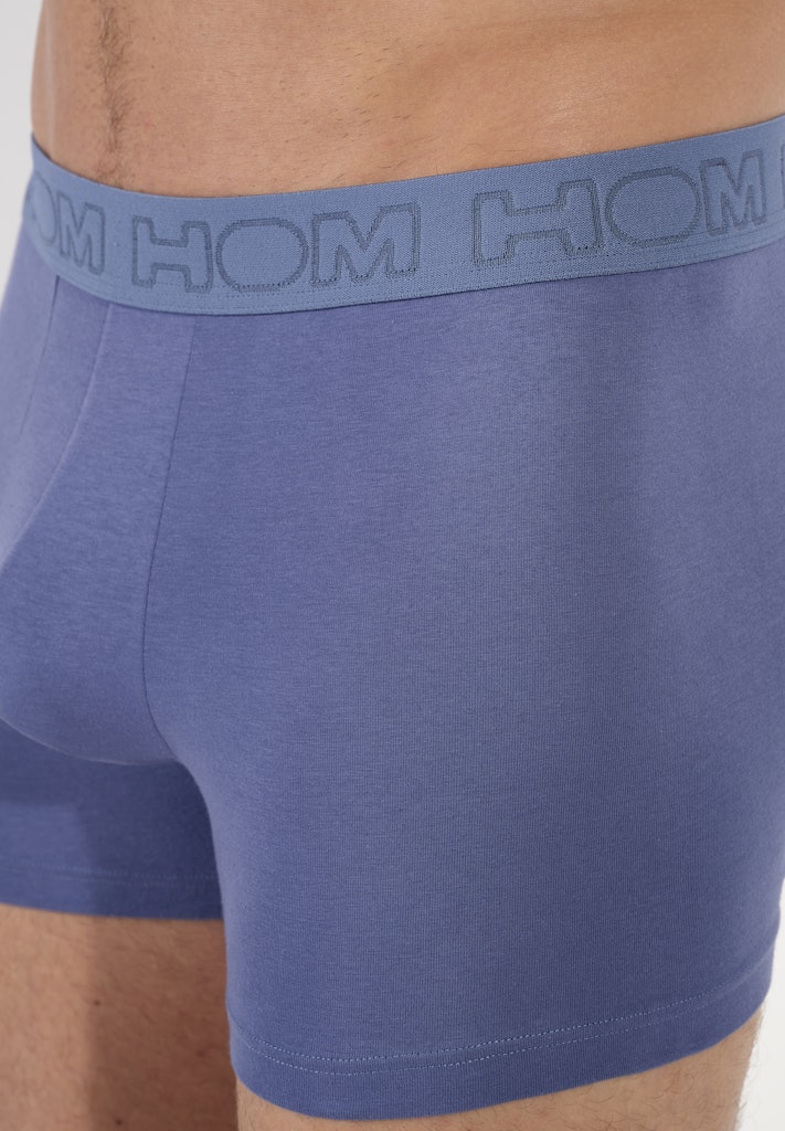 Blue boxer briefs with a visible brand logo on the waistband.