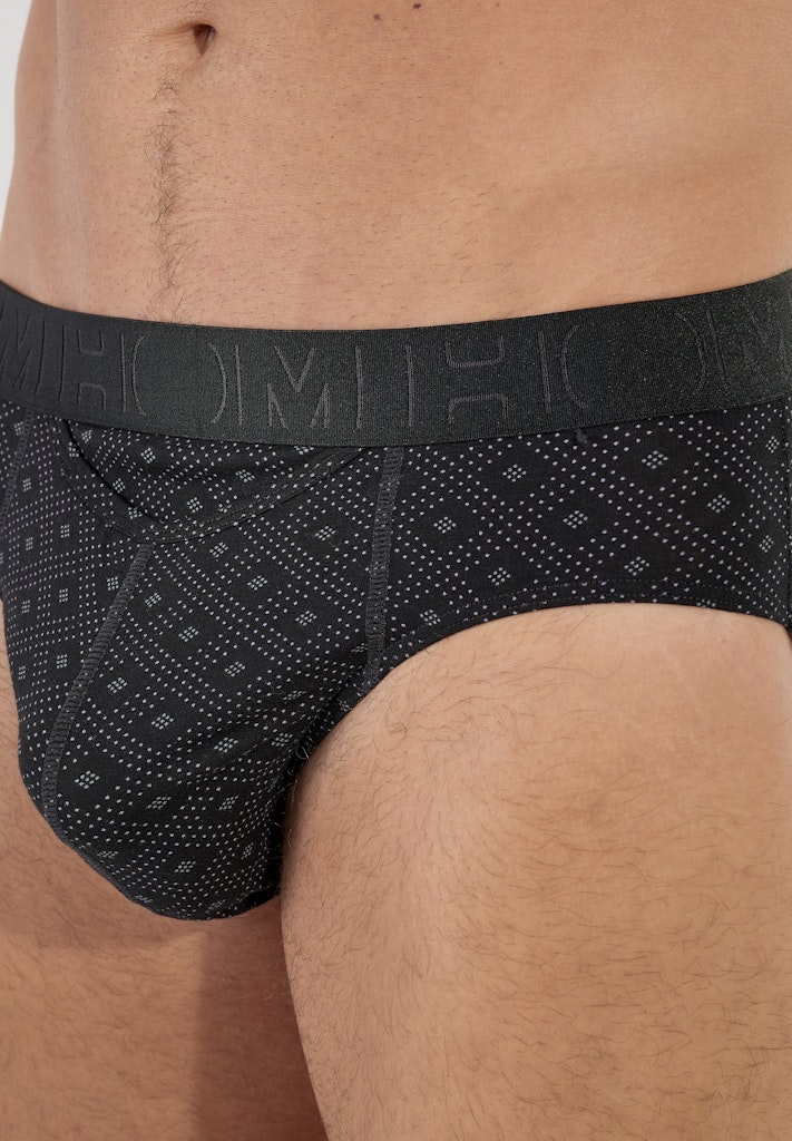 Black patterned men's underwear worn by a person.