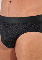 Black patterned men's underwear worn by a person.