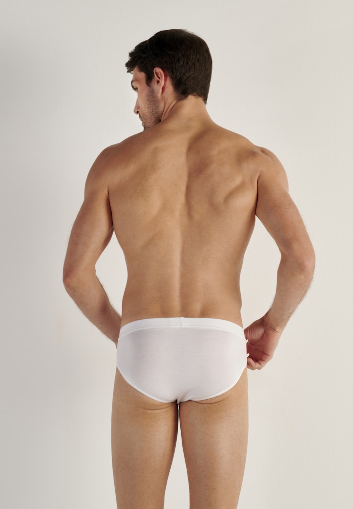 Man wearing a white underwear on a plain background