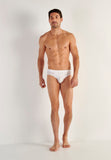 Man wearing a white men's underwear on a plain background