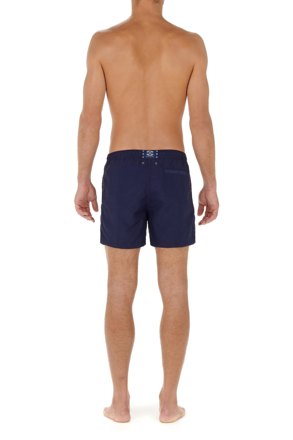 Person wearing navy blue swim shorts on a white background