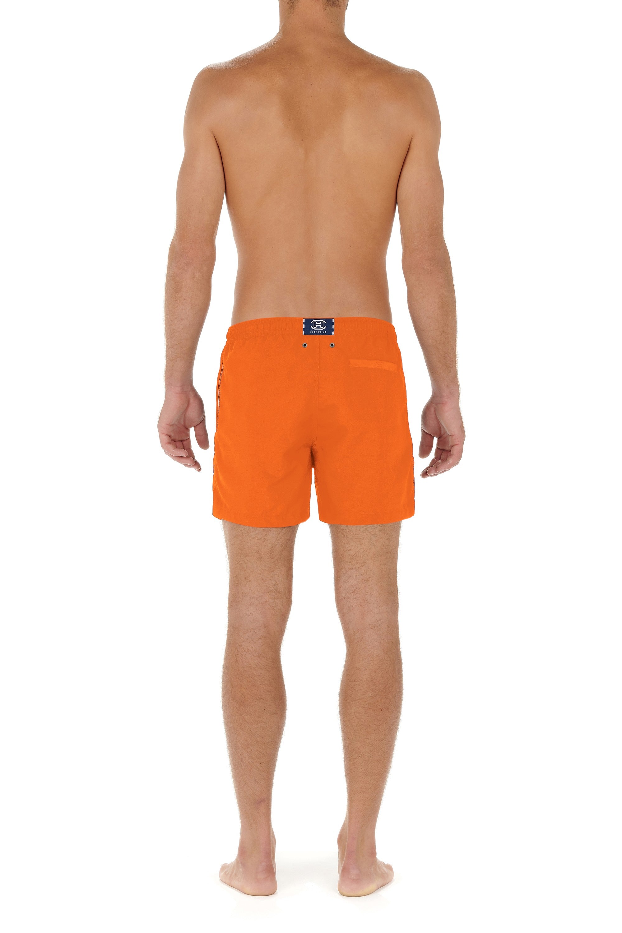 Person wearing bright orange swim shorts on a white background
