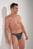 Man wearing a colorful floral-patterned thong against a plain background