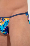 Colorful tanga briefs with abstract design on a person against a neutral background