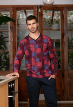 Man wearing a red and blue patterned long sleeve top and navy pants in a kitchen setting