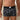 Person wearing black boxer briefs with colorful pattern in a bathroom setting
