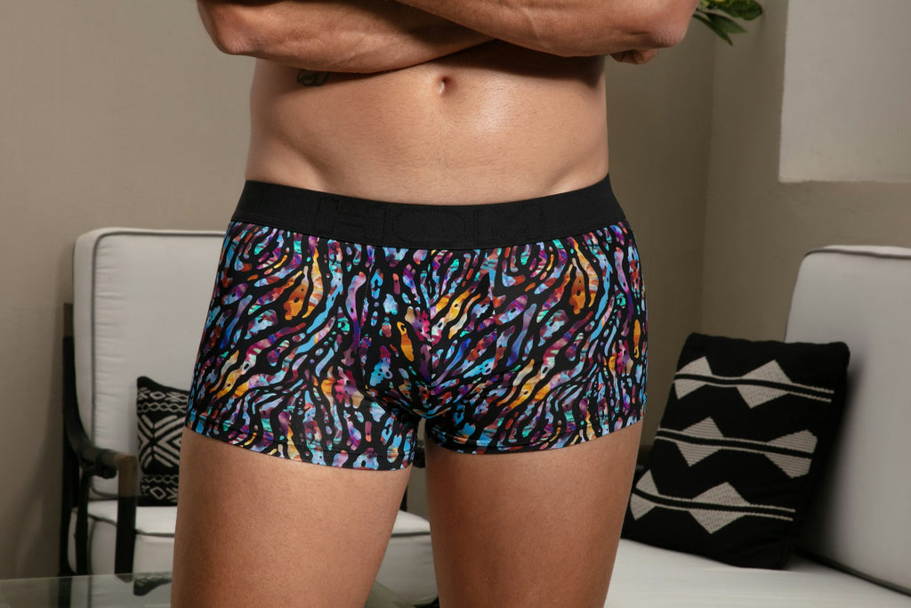 Person wearing colorful patterned underwear in a living room setting