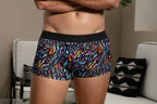 Person wearing colorful patterned underwear in a living room setting