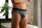 Person wearing a patterned underwear in a bathroom setting